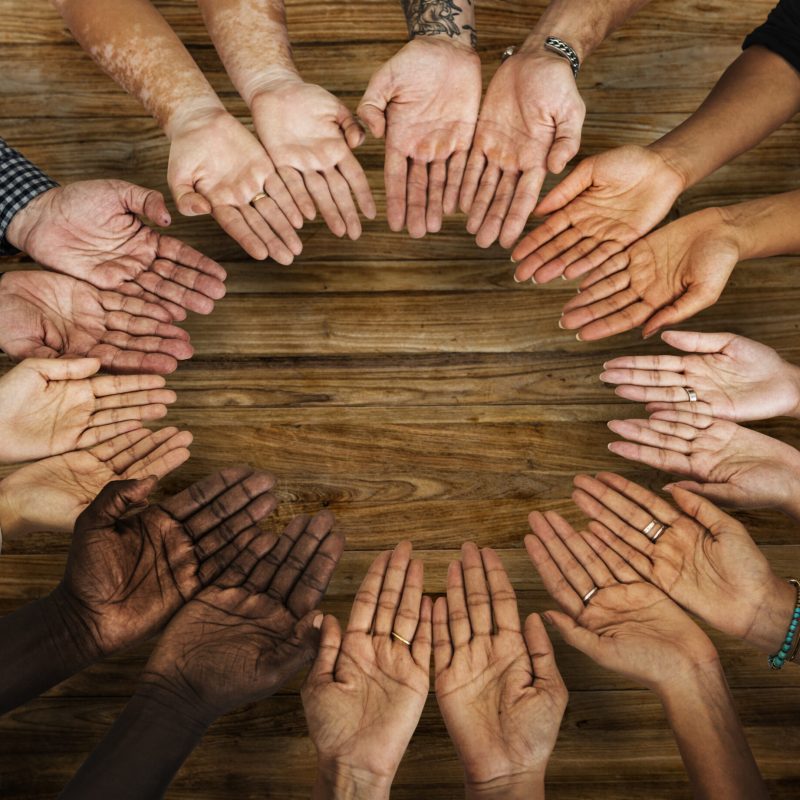 DIverse hands are together in a circle shape